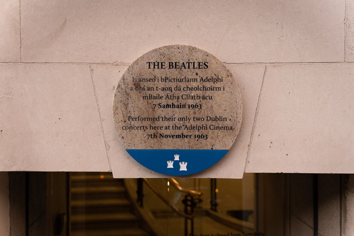 Round Dublin City Council plaque in Irish and English marking the Beatles' only two Dublin concerts at the Adelphi Cinema, 7 November 1963
