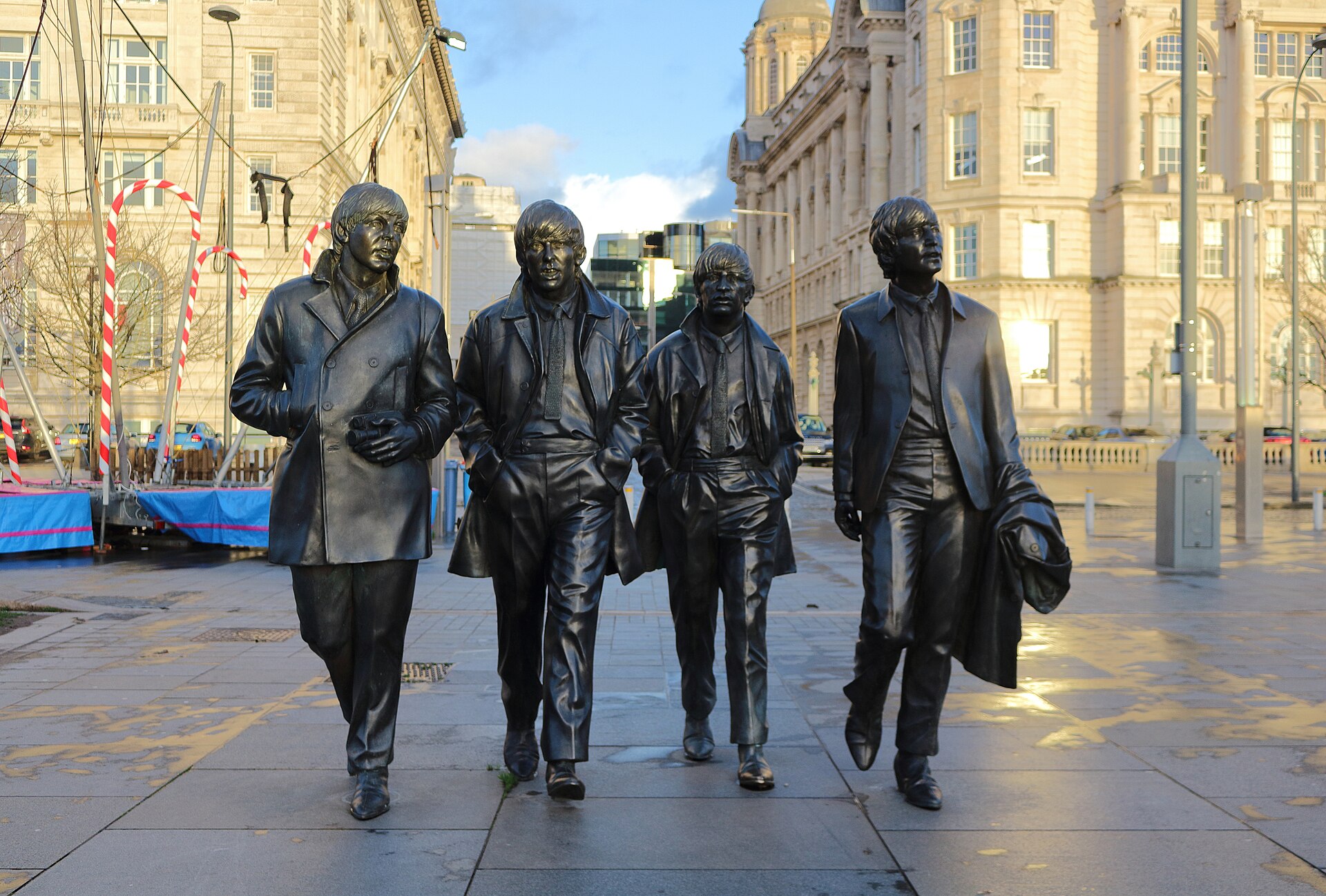 Bronze Beatles Statue by Andy Edwards at Pier Head, Liverpool, showing the four band members walking