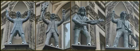 The four Beatles statues in niches high on the facade of the Hard Days Night Hotel, North John Street, Liverpool