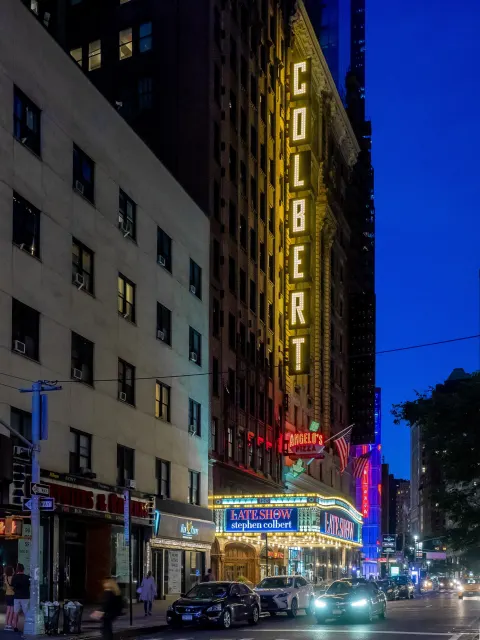 The Ed Sullivan Theater marquee on Broadway, New York City, lit at night in June 2019