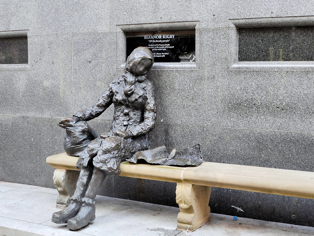 Tommy Steele's bronze Eleanor Rigby statue seated on its bench on Stanley Street, Liverpool, photographed in October 2024
