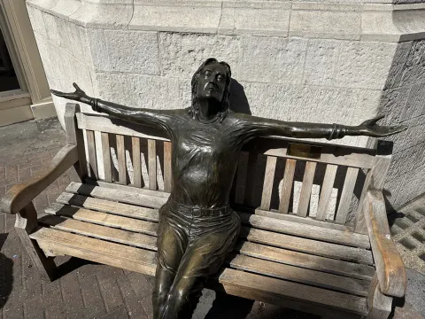 Lawrence Holofcener's bronze Imagine statue of John Lennon on a bench on Carnaby Street, London