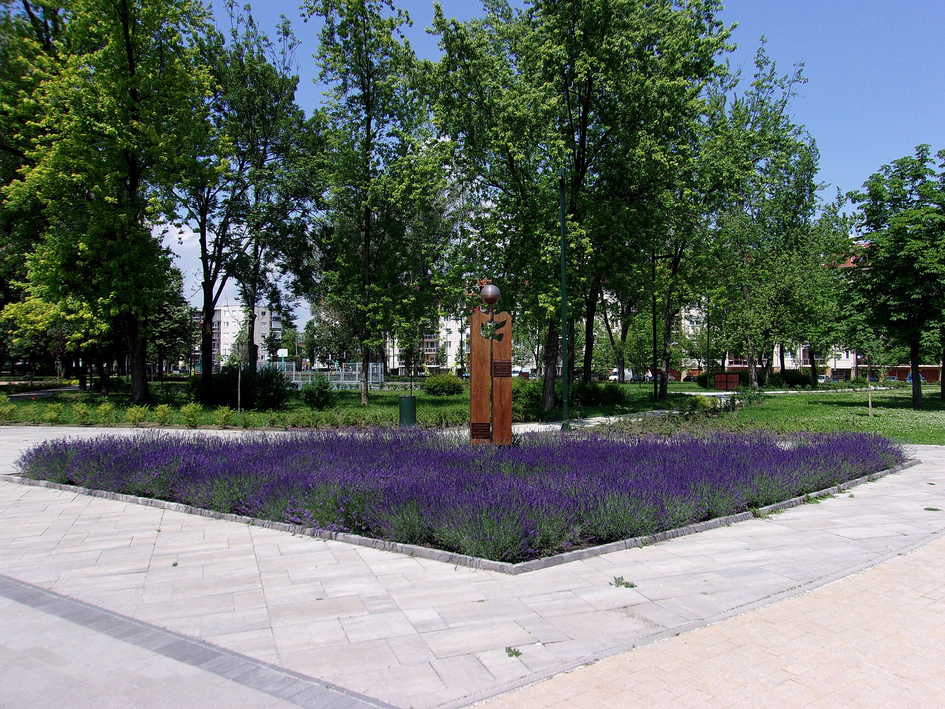 The John Lennon memorial column with dove and metal globe on Fő tér, Kazincbarcika, photographed in June 2020