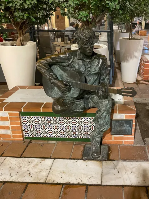 Carmen Mudarra's bronze statue of John Lennon playing guitar in Plaza Flores, Almería