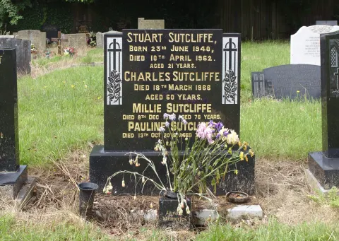 Black headstone of Stuart Sutcliffe's family grave in the churchyard of St Michael's Church, Huyton, 2021