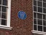 Round blue plaque on the brick front of 3 Savile Row, London, marking the Beatles' rooftop performance of 30 January 1969
