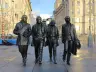 Bronze Beatles Statue by Andy Edwards at Pier Head, Liverpool, showing the four band members walking