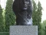 Bronze bust of John Lennon on a granite pedestal in the Aleja Sław, Kielce, photographed in June 2011